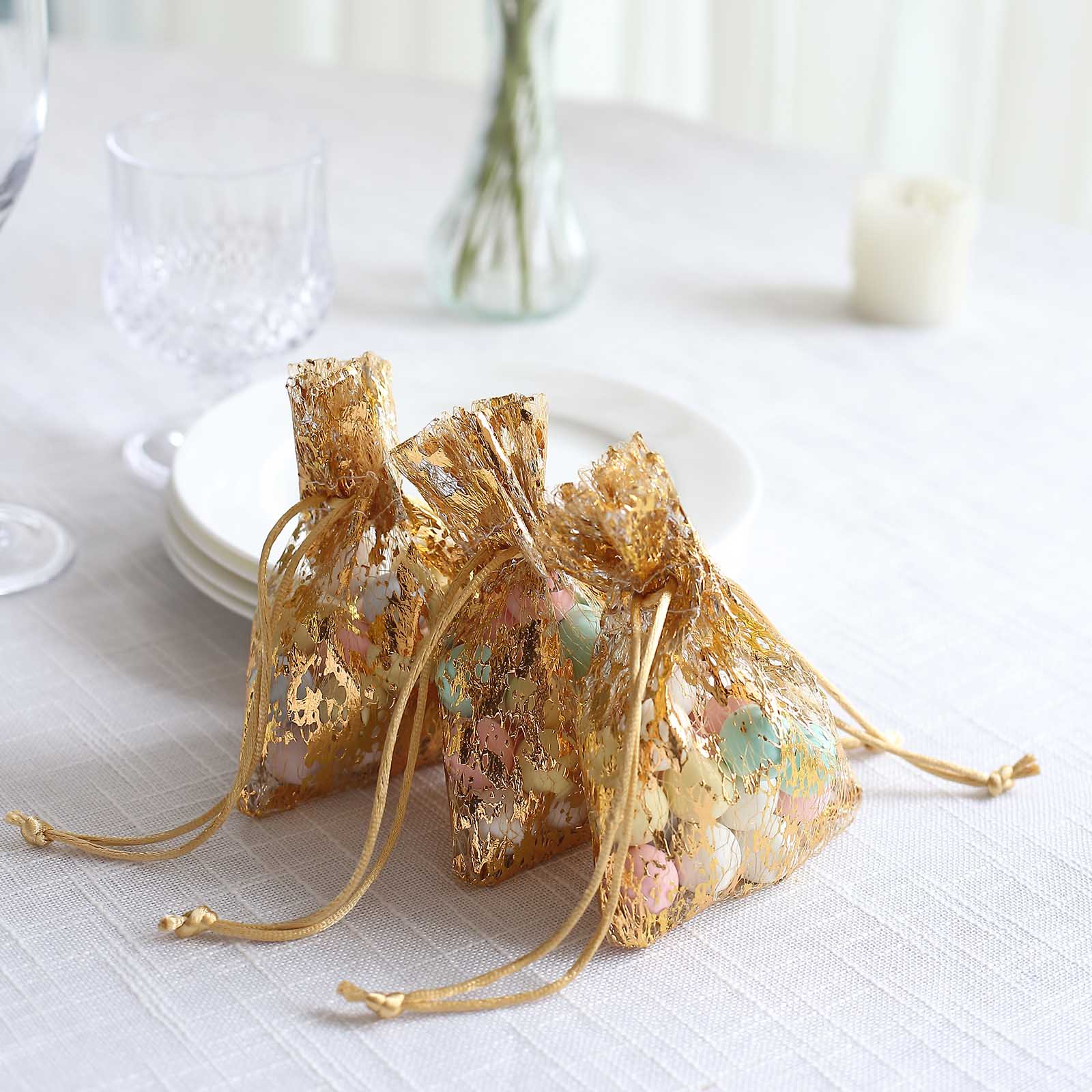 Metallic gold foil drawstring candy bags for wedding party favors.
