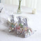 Metallic silver foil drawstring candy bags for wedding party favors.