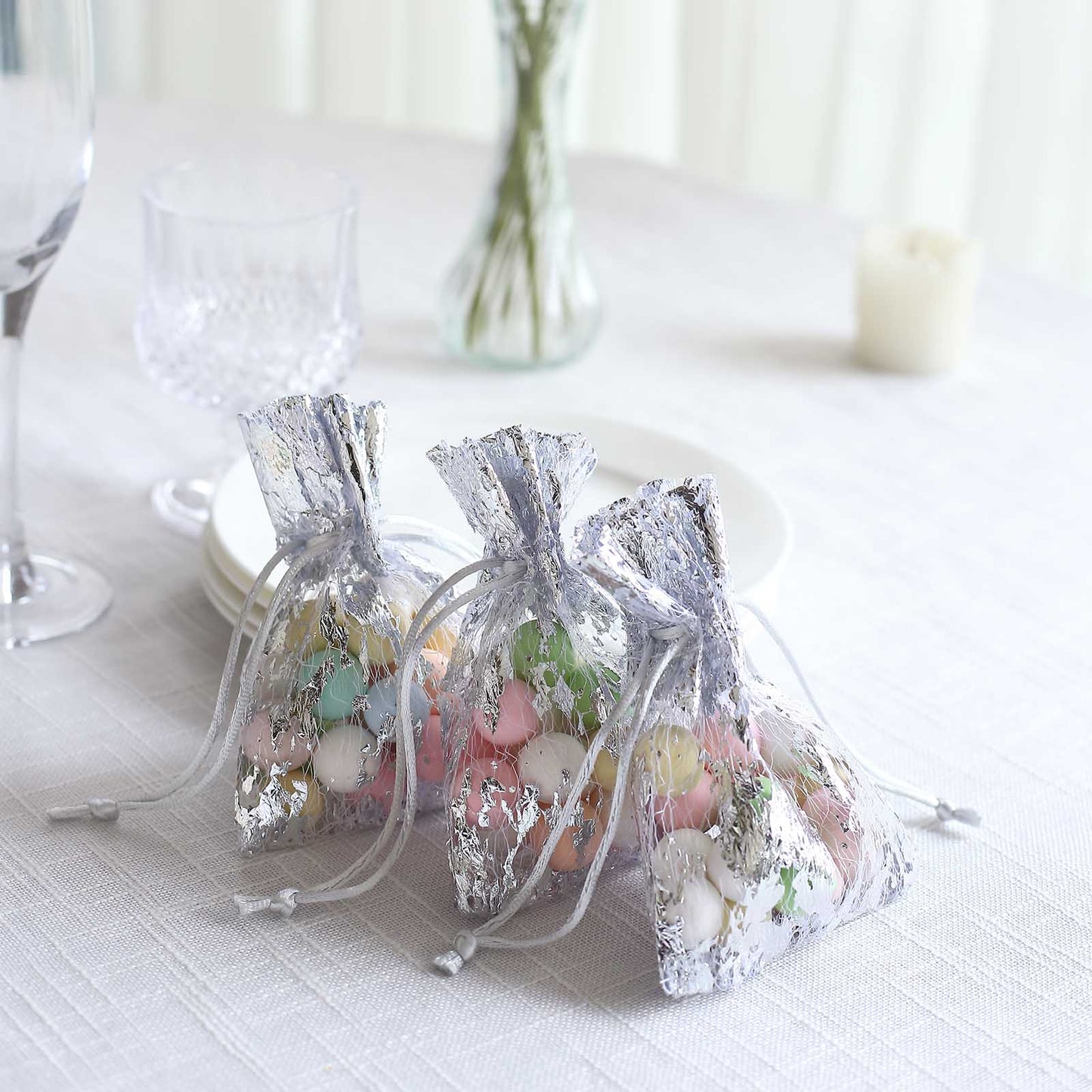 Metallic silver foil drawstring candy bags for wedding party favors.