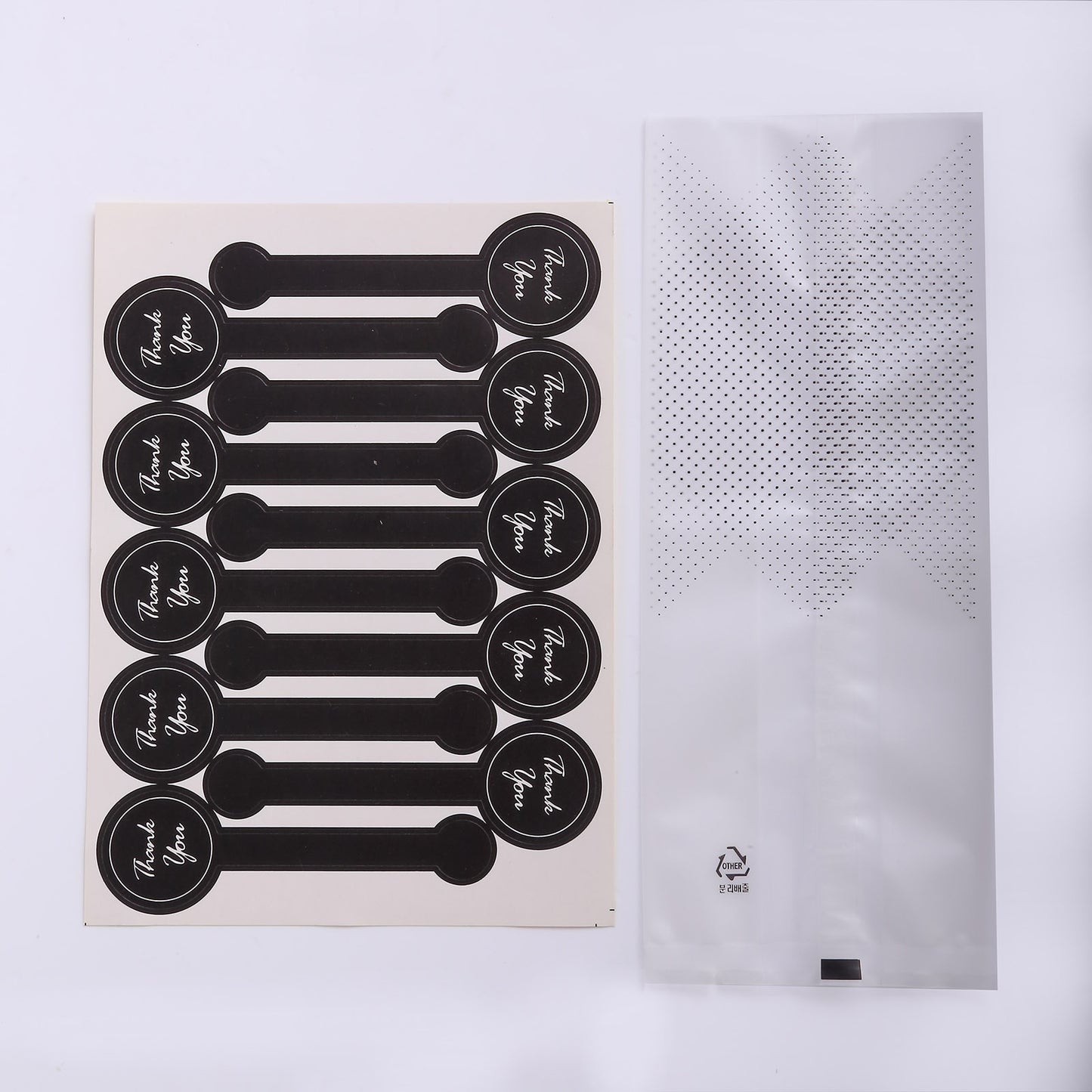 Clear black dotted goodie bags with "Thank You" stickers, perfect for party favors.