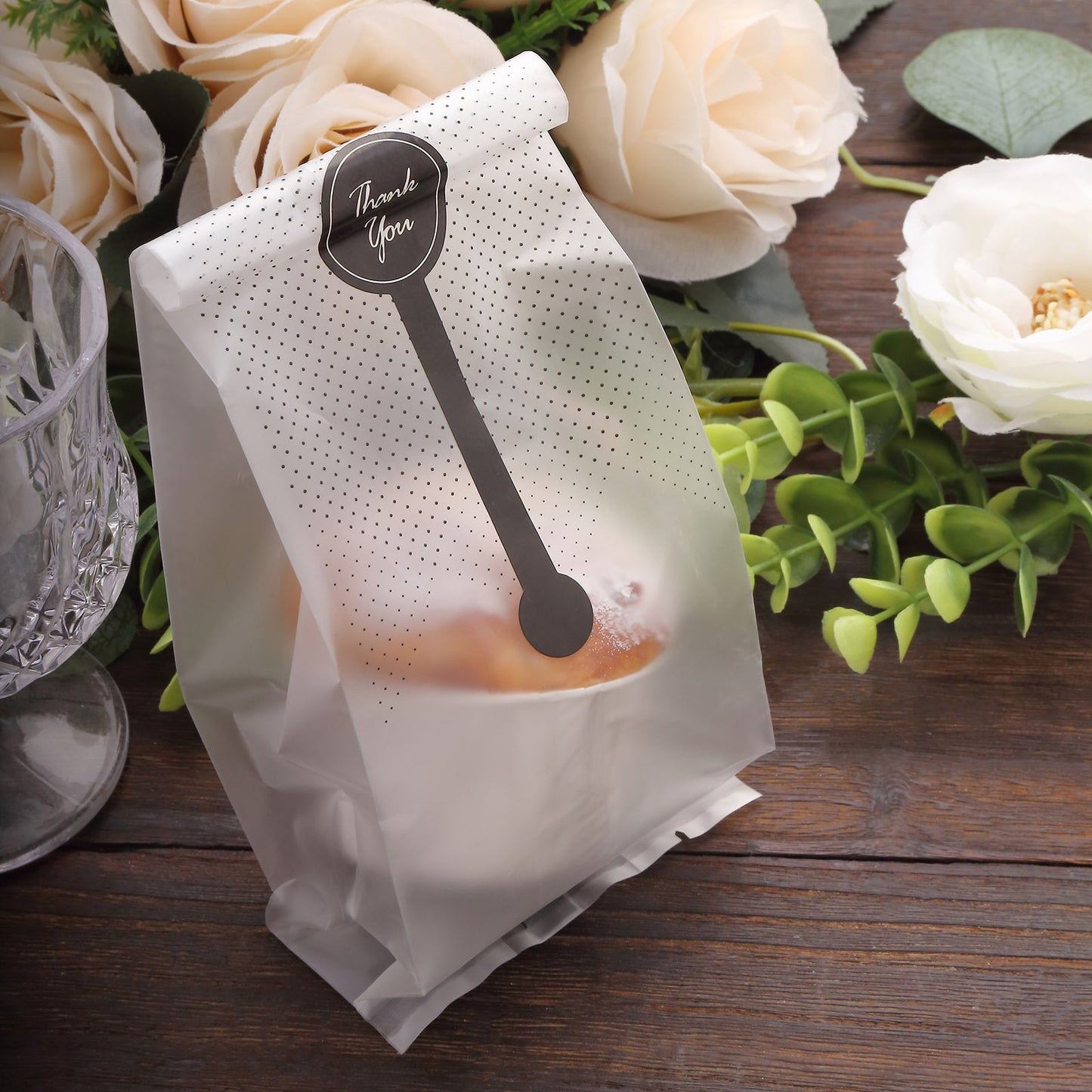 Clear black dotted gift bag with "Thank You" sticker for party favors.