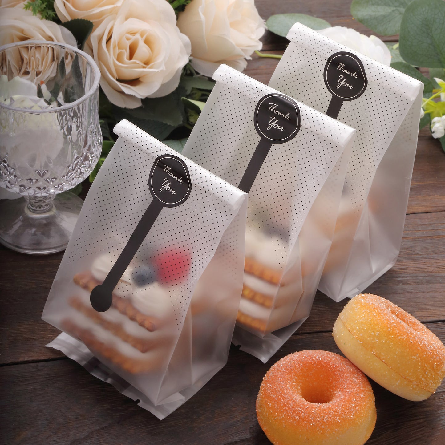 Clear black dotted gift bags with "Thank You" stickers, perfect for party favors.