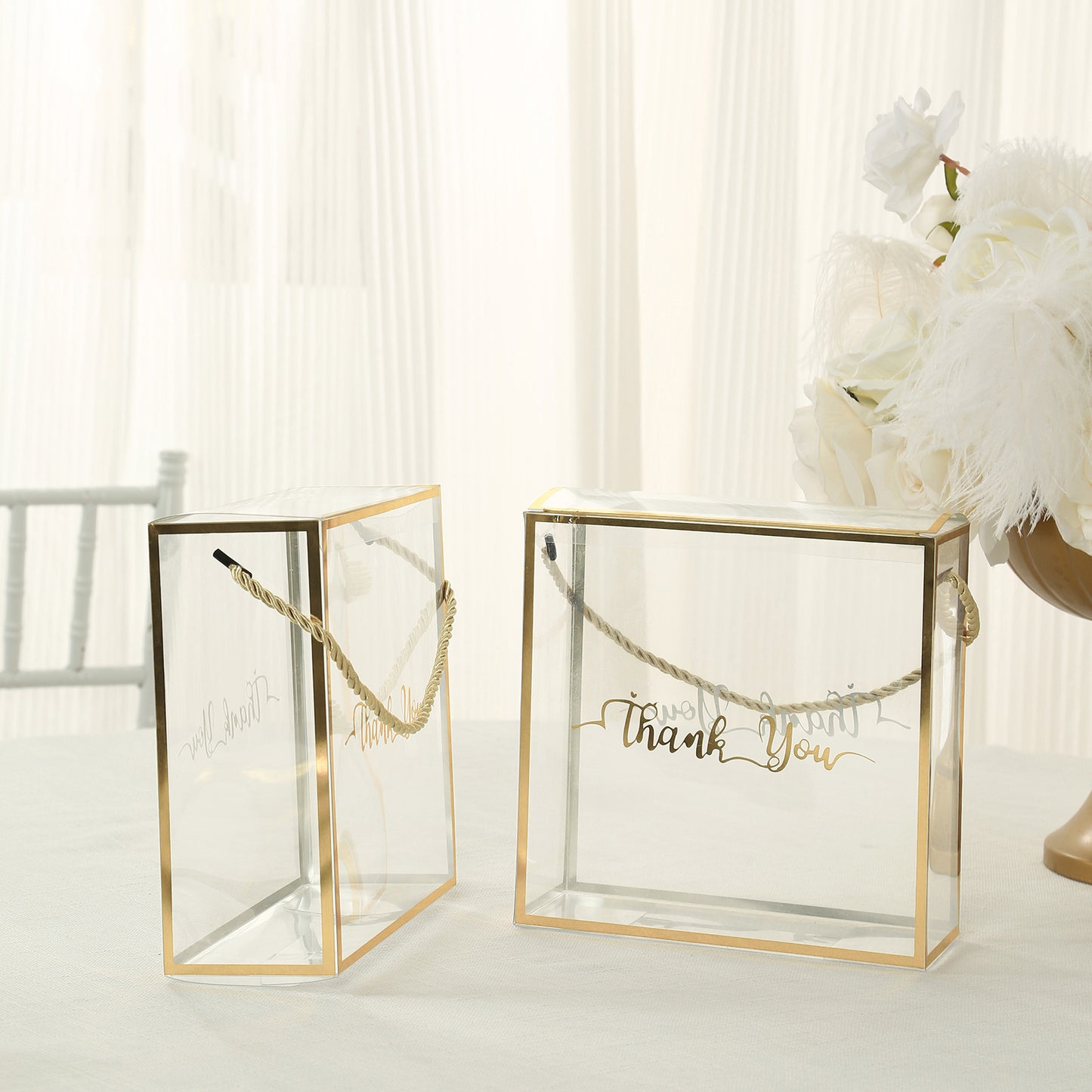 Gold trimmed clear PVC gift boxes with rope handles and thank you print.