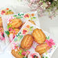 Clear white PVC favor bags with floral print and self-adhesive seal.