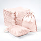 Blush satin drawstring favor bags, perfect for weddings and parties.