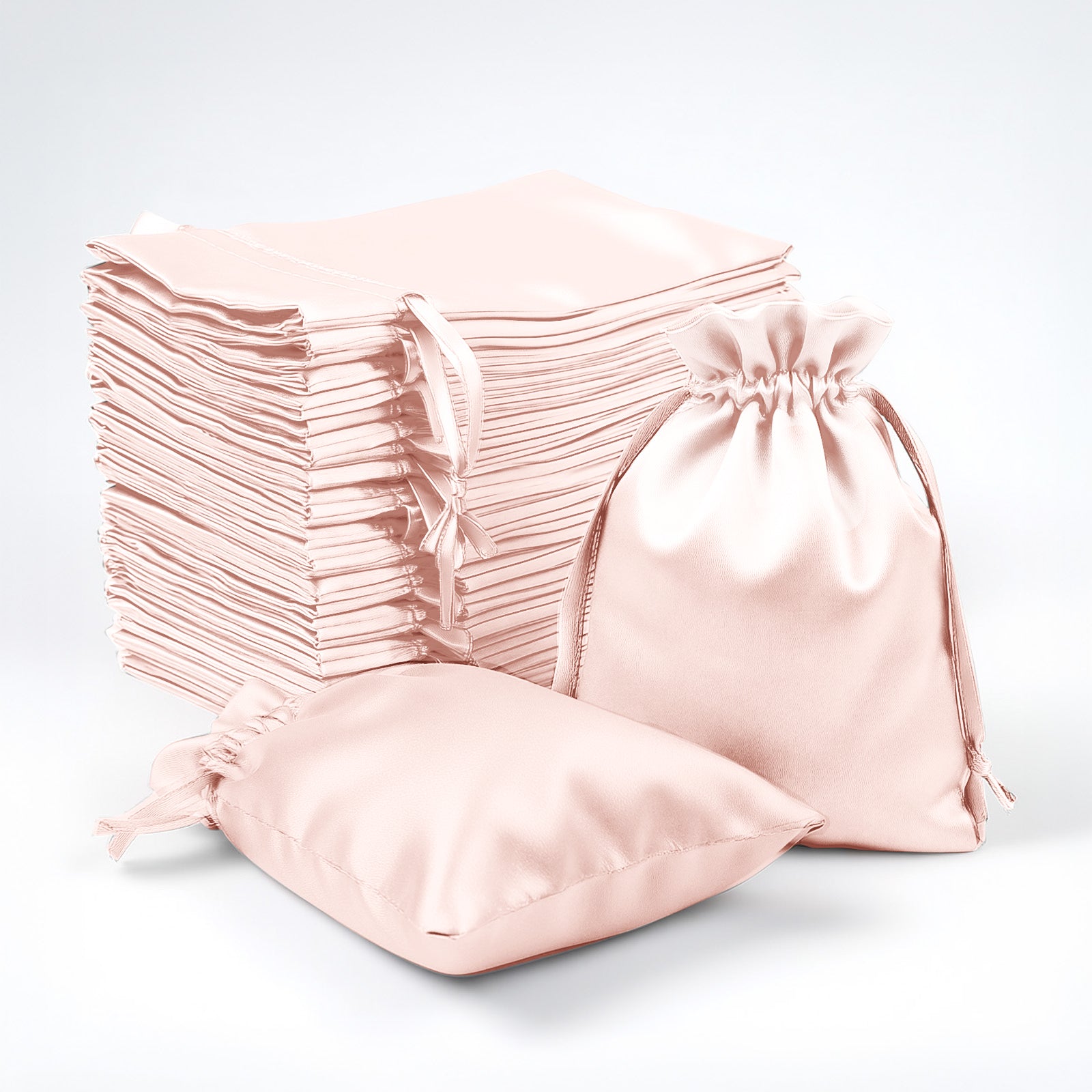 Blush satin drawstring favor bags, perfect for weddings and parties.