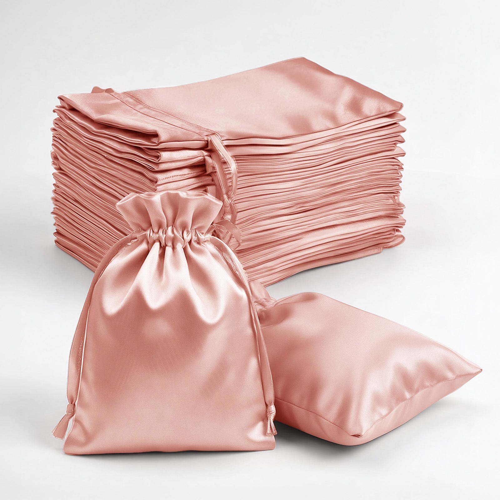 Dusty rose satin drawstring favor bags, perfect for weddings and parties.