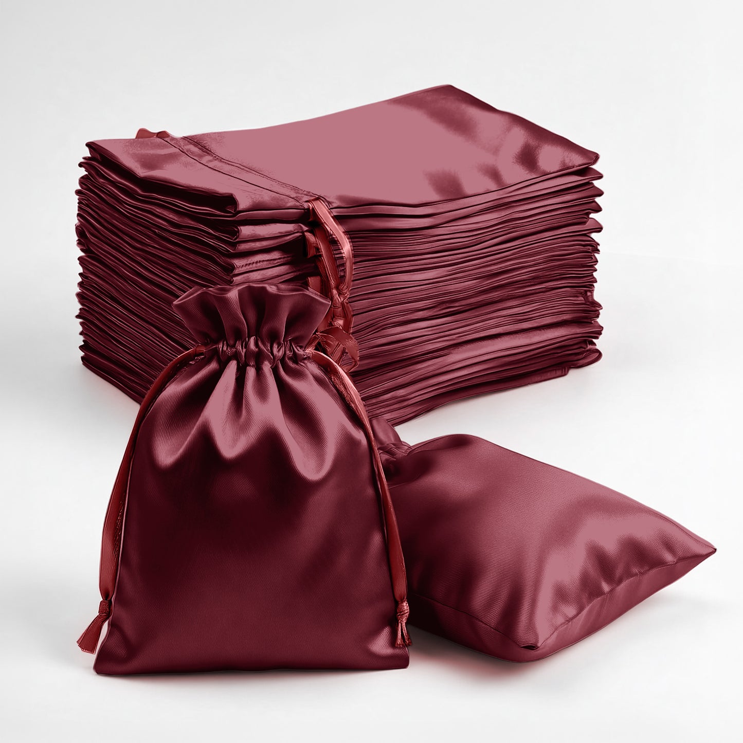 Burgundy satin drawstring favor bags for weddings and parties.