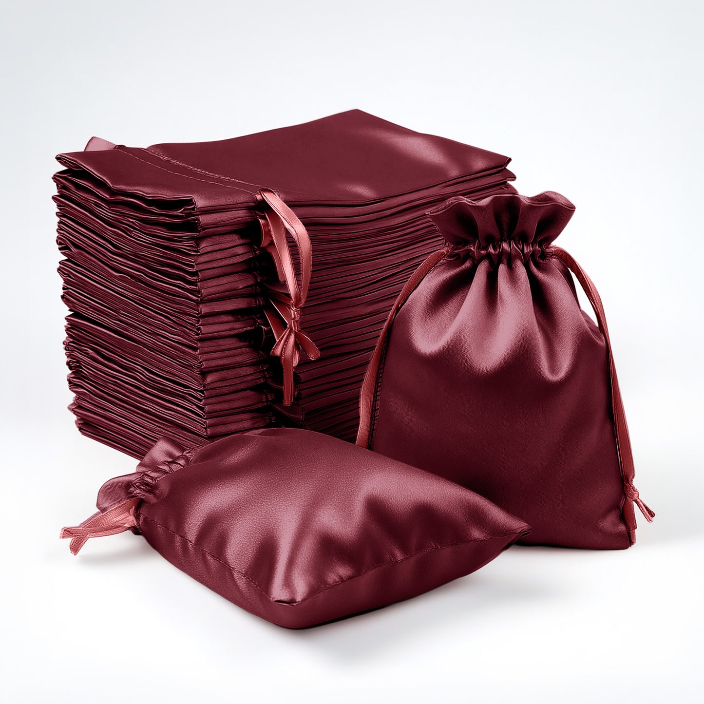 Burgundy satin drawstring favor gift bags for weddings and parties.