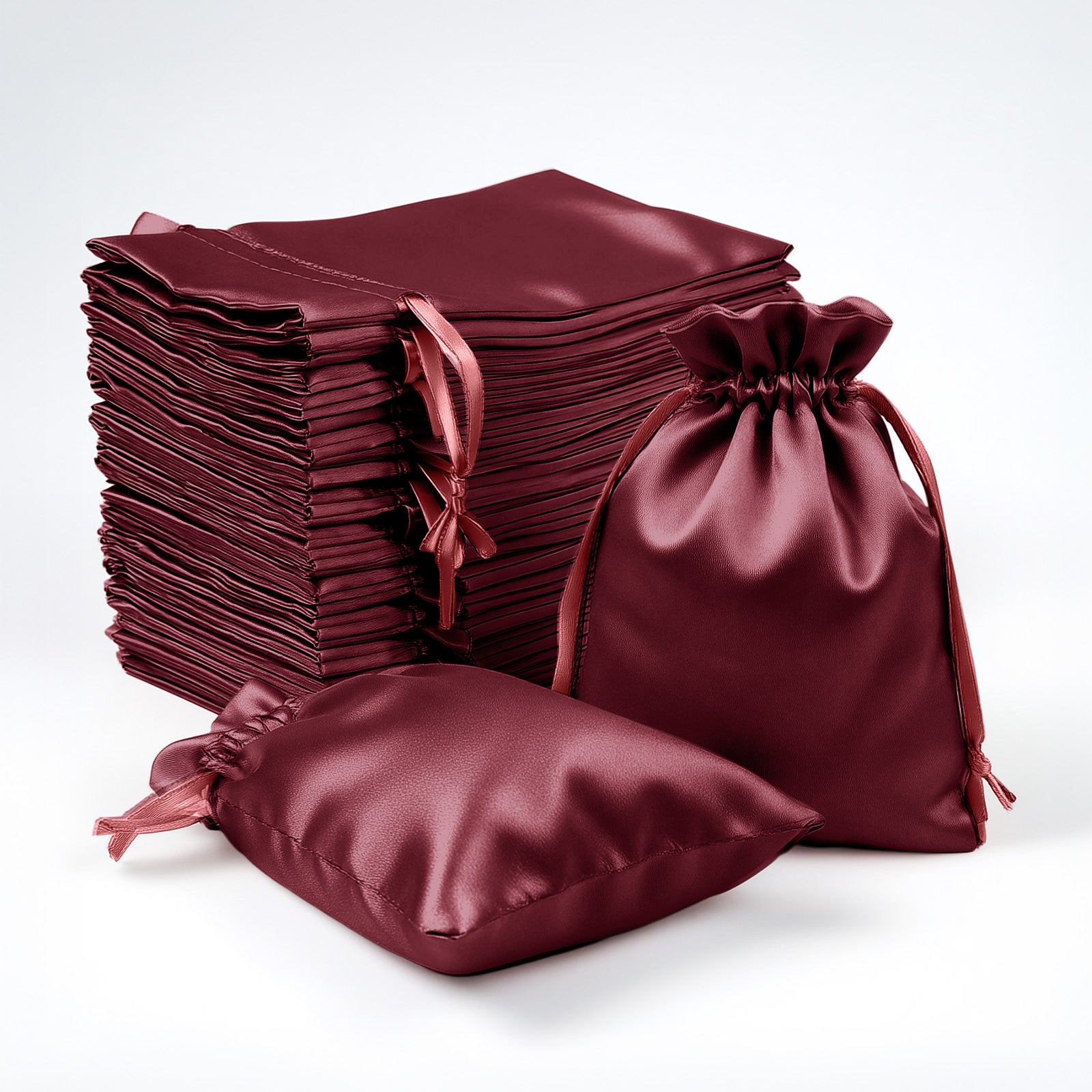 Burgundy satin drawstring favor gift bags for weddings and parties.