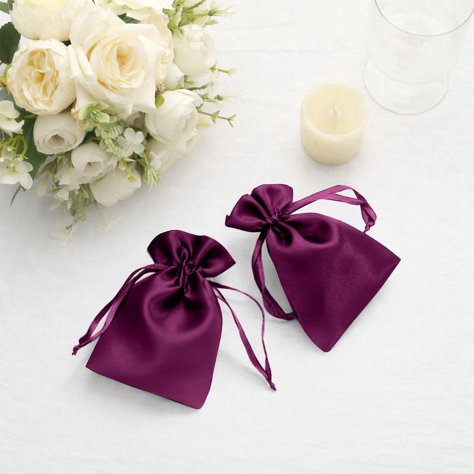 Eggplant satin drawstring favor bags for weddings and parties.