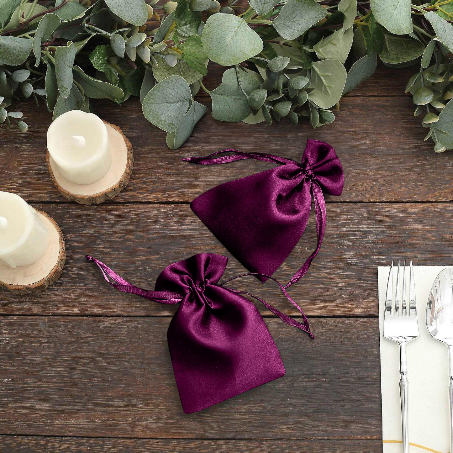 Eggplant satin drawstring favor bags for weddings and parties.