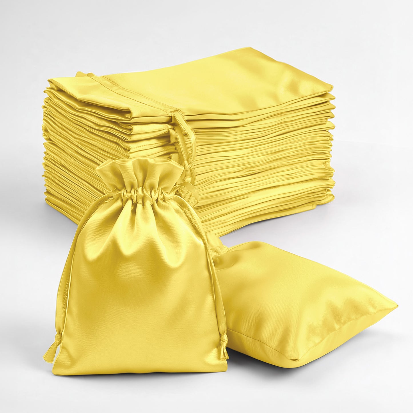 Yellow satin drawstring favor bags, 3"x4", ideal for weddings and parties.