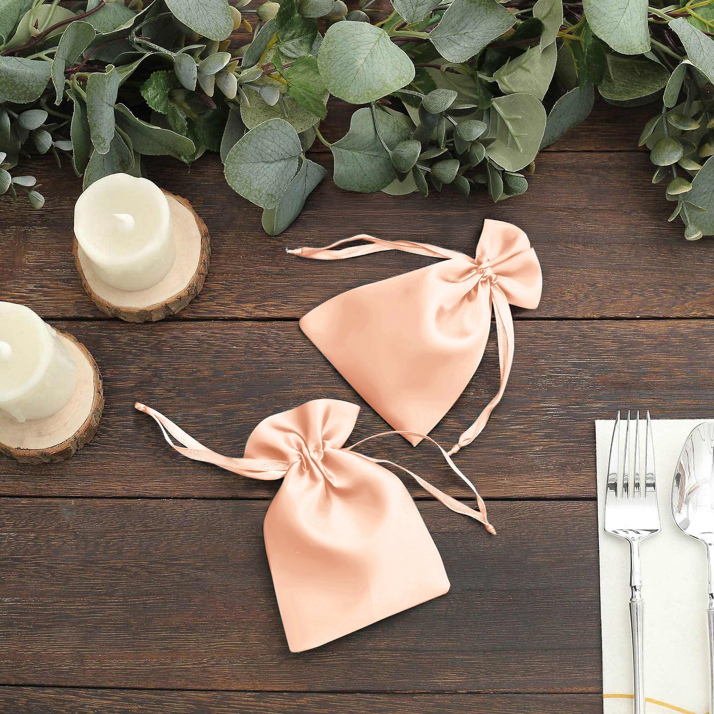 Peach satin drawstring favor bags for weddings and parties.