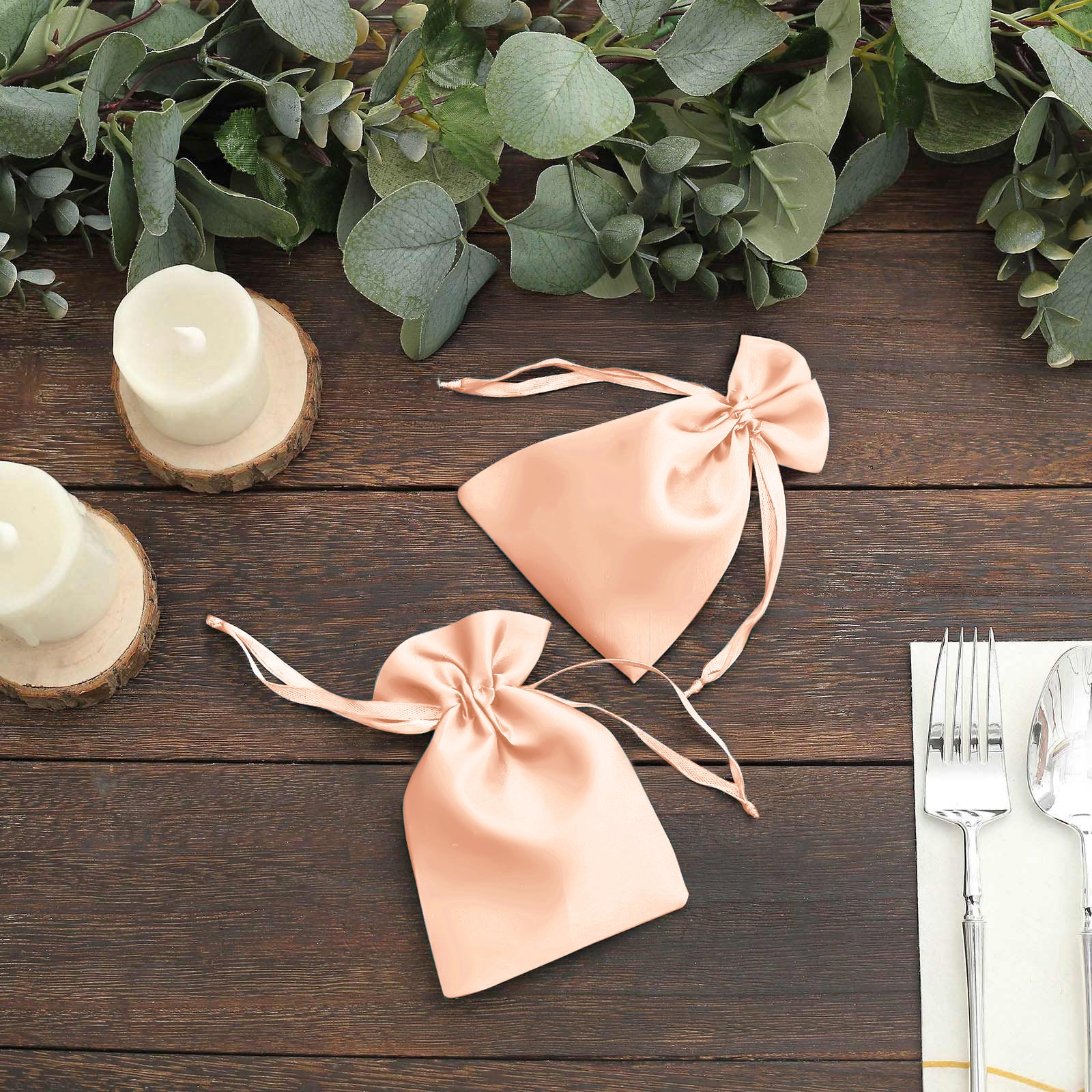 Peach satin drawstring favor bags for weddings and parties.