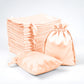 Peach satin drawstring favor bags, 60 pack for weddings and parties.