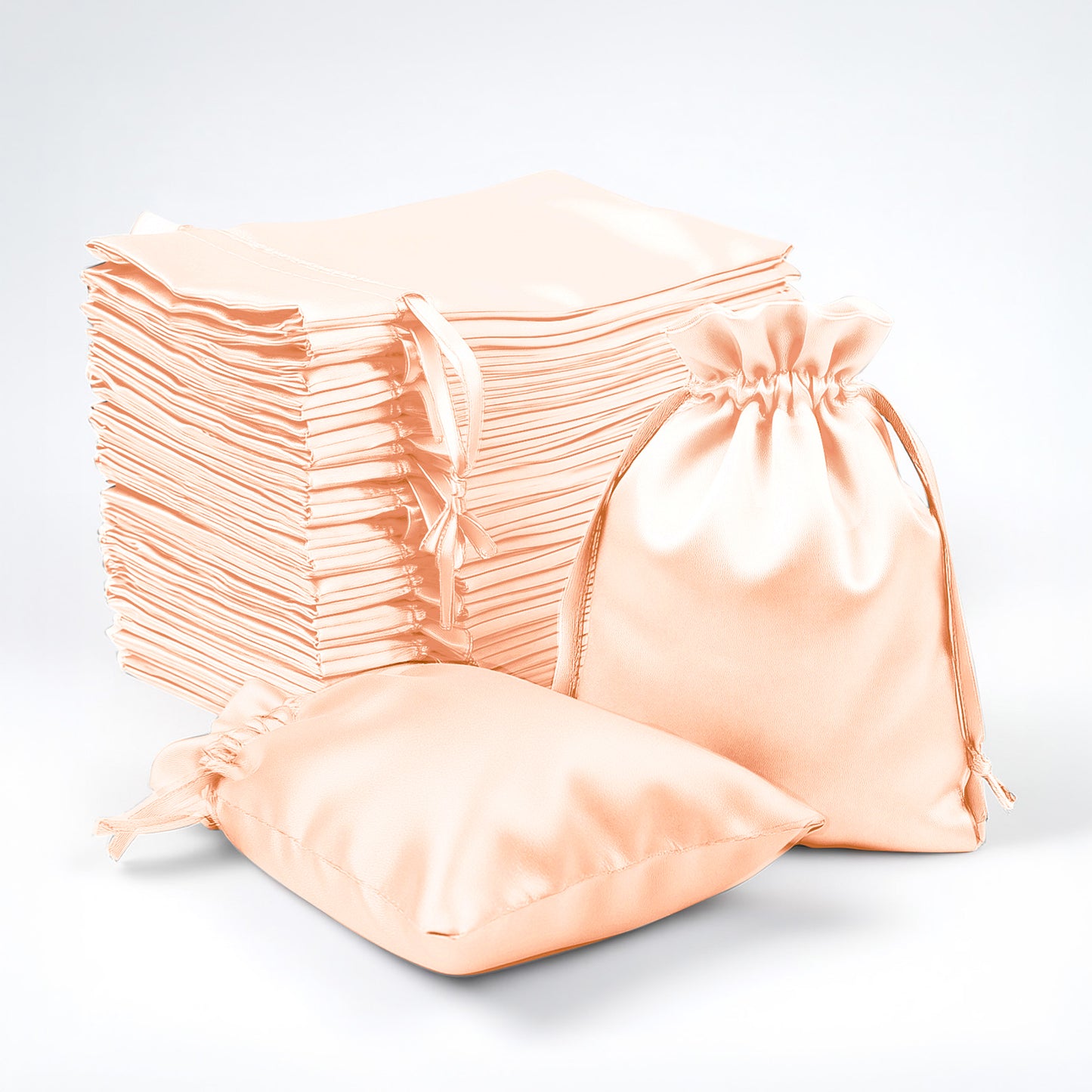 Peach satin drawstring favor bags, 60 pack for weddings and parties.
