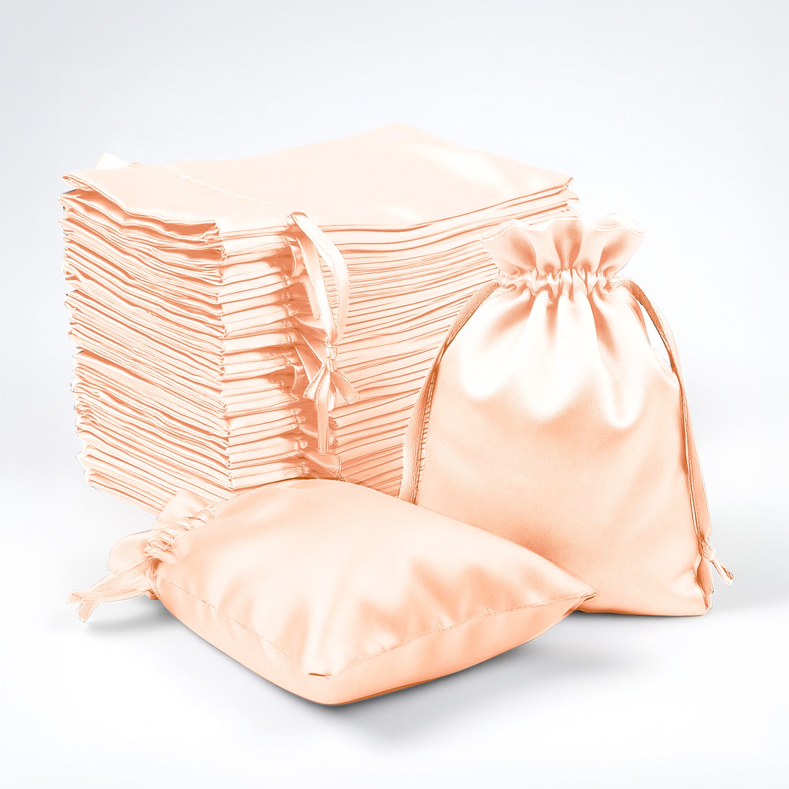 Peach satin drawstring favor bags, 60 pack for weddings and parties.