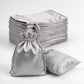 Silver satin drawstring favor bags for weddings and parties.