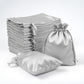 Silver satin drawstring favor bags, 60 pack for weddings and parties.