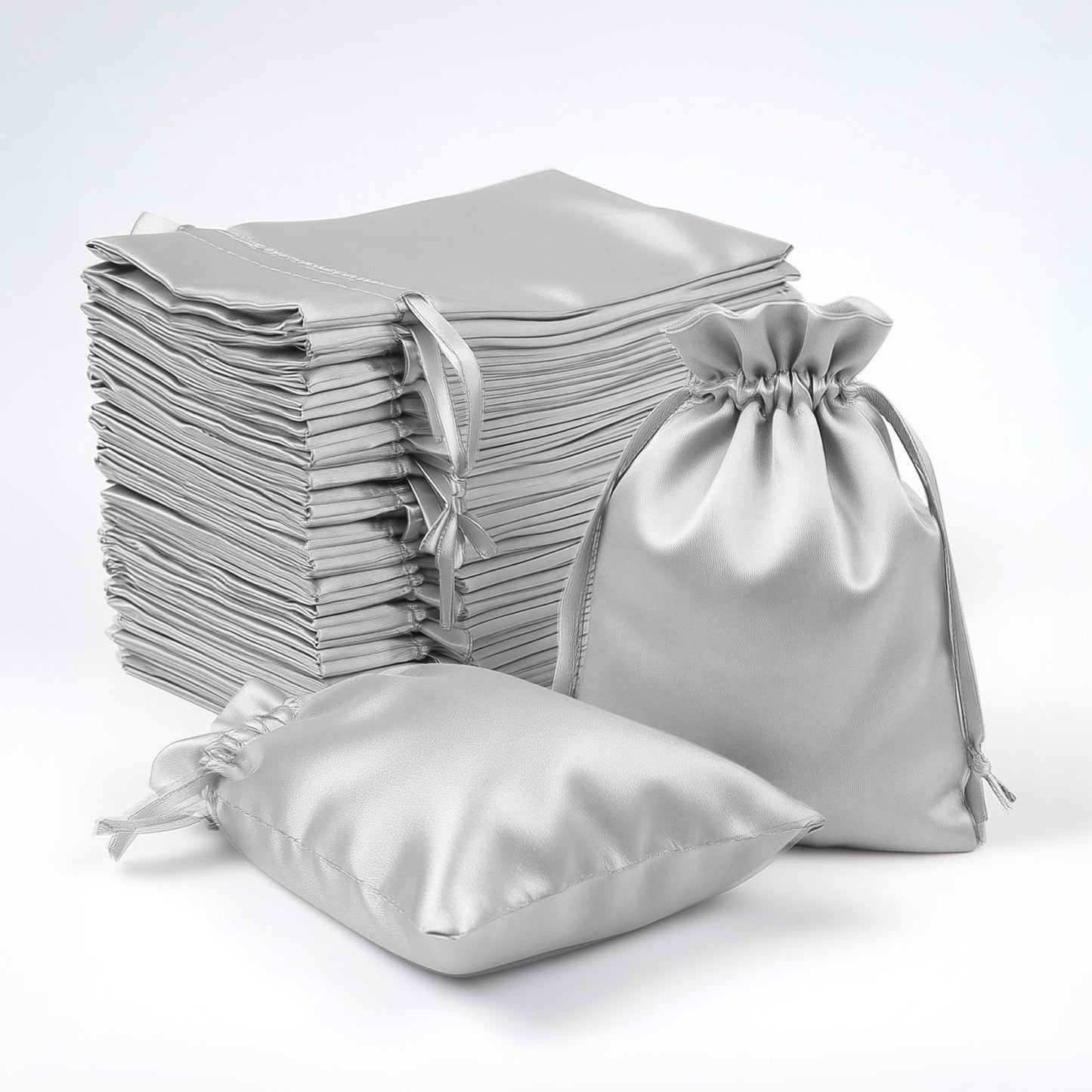Silver satin drawstring favor bags, 60 pack for weddings and parties.