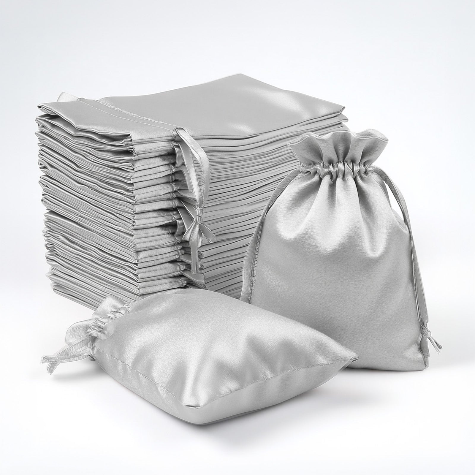 Silver satin drawstring favor bags, 60 pack for weddings and parties.