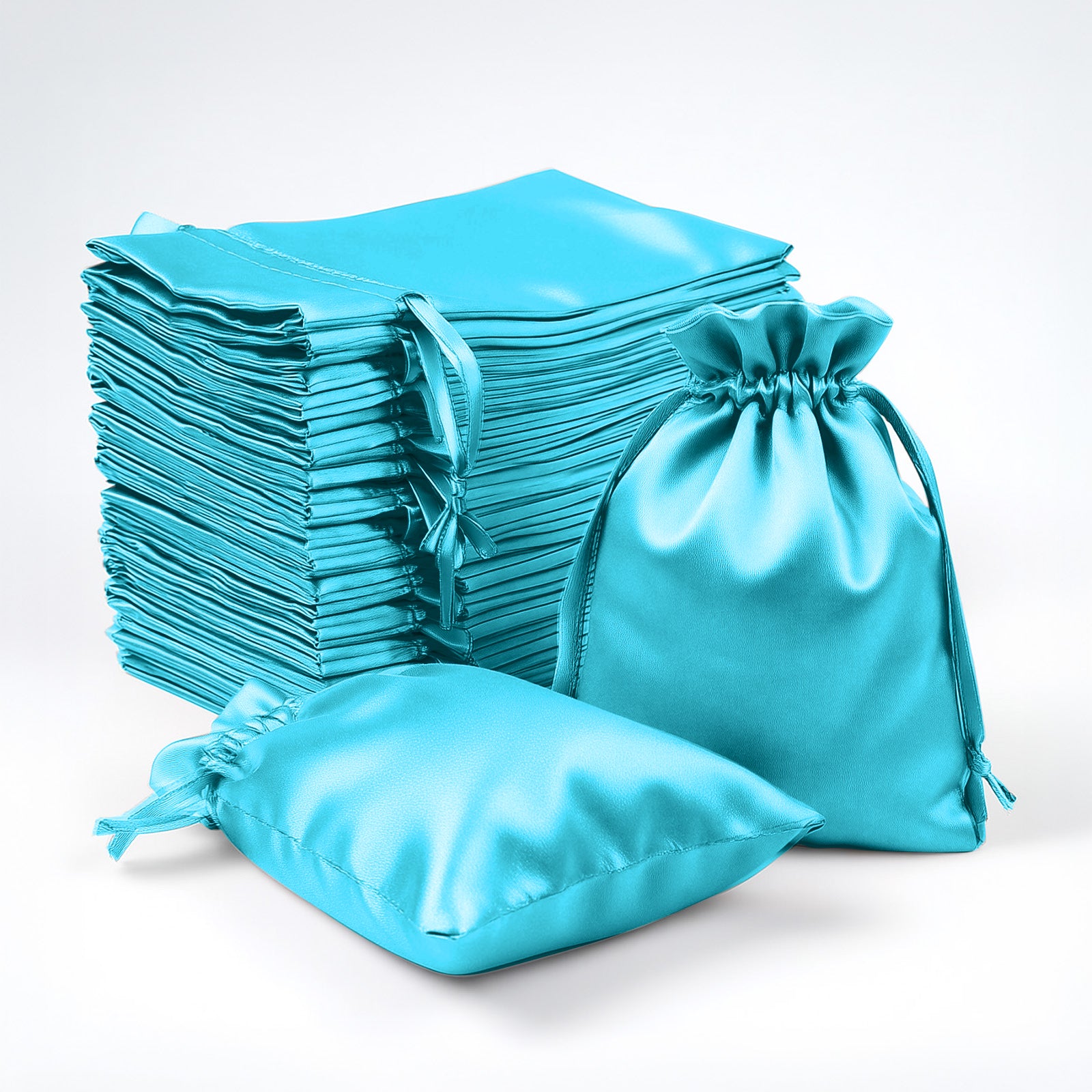 Turquoise satin drawstring favor bags for weddings and parties.