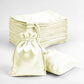 Yellow satin drawstring favor bags stacked and displayed.