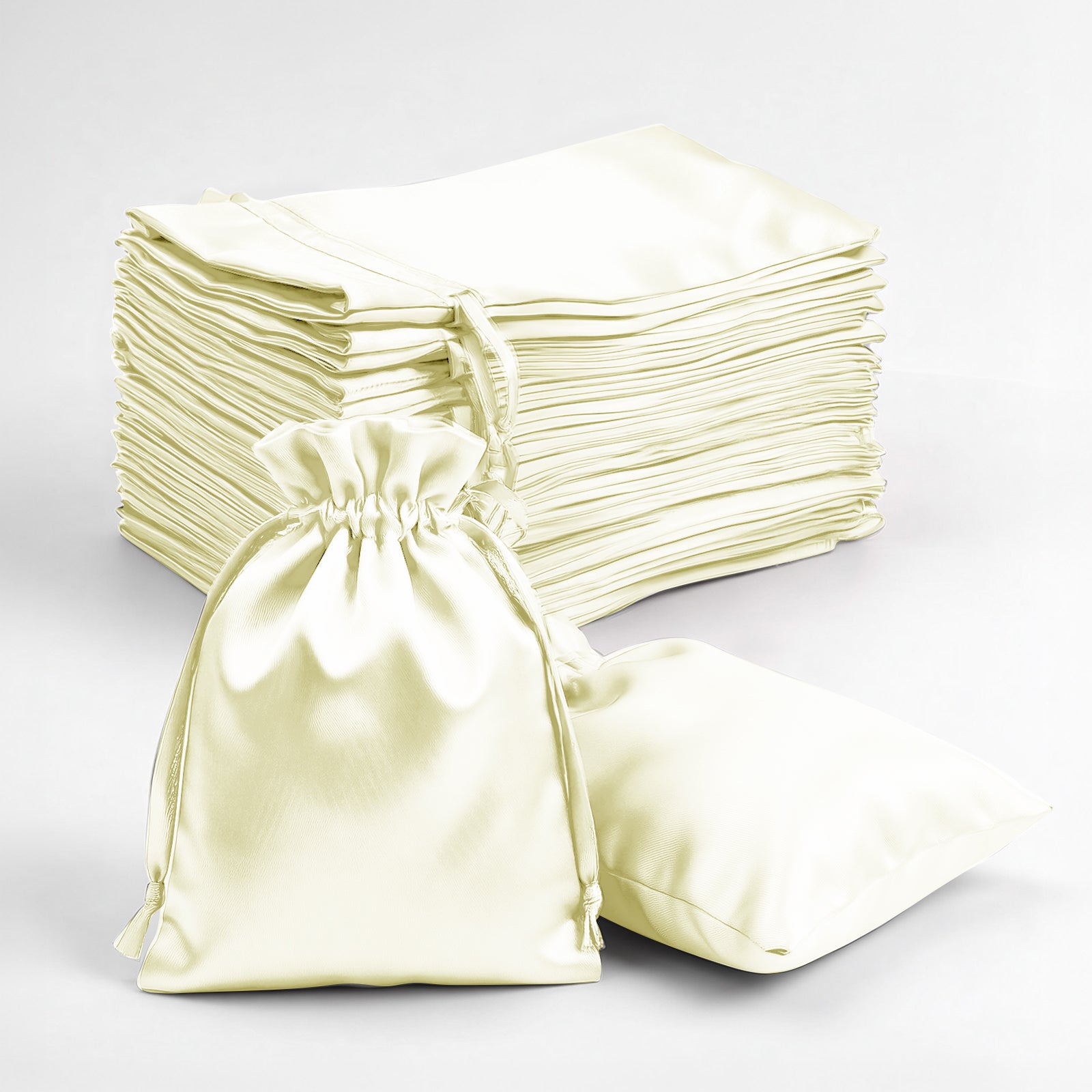 Yellow satin drawstring favor bags stacked and displayed.