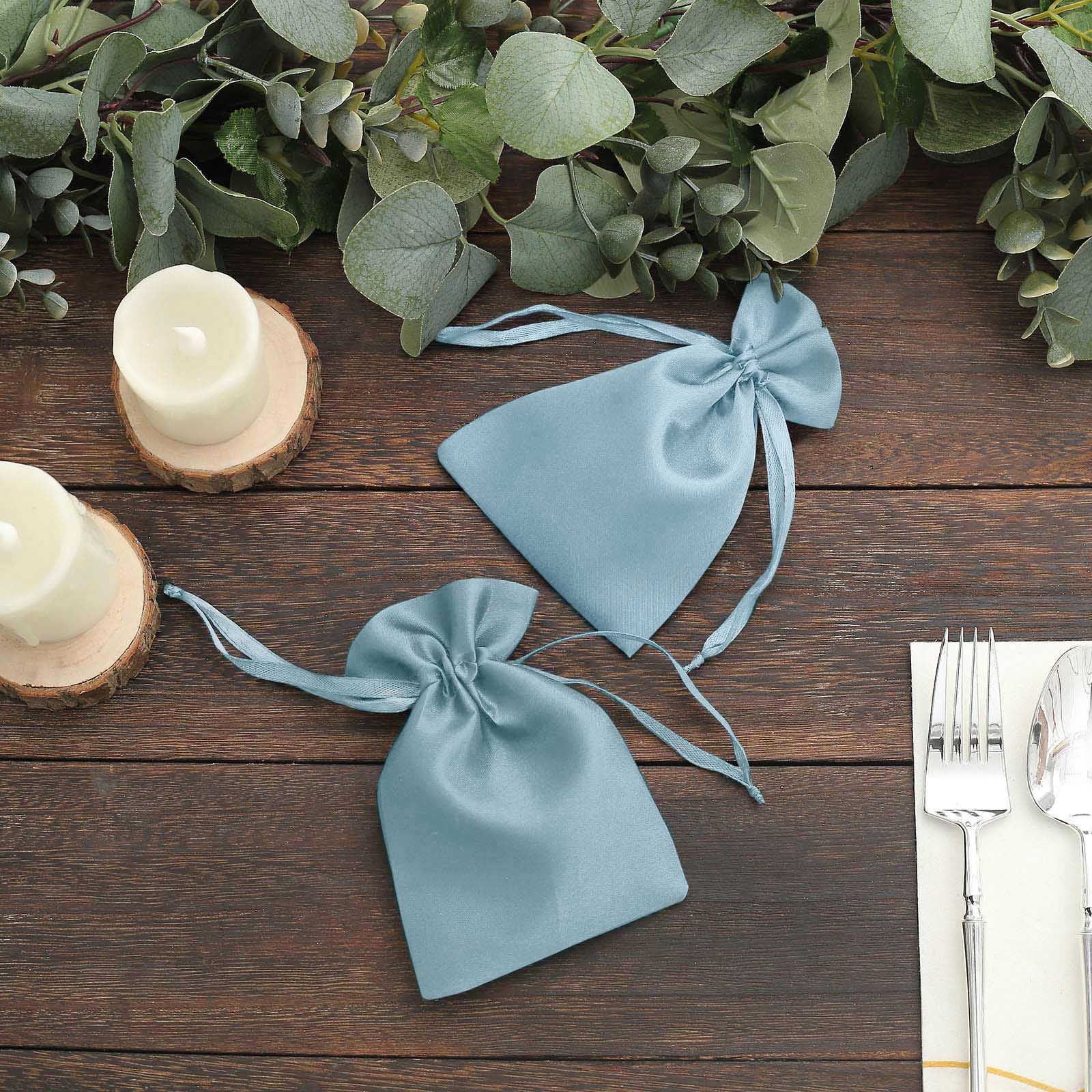 Dusty blue satin drawstring favor bags for weddings and parties.