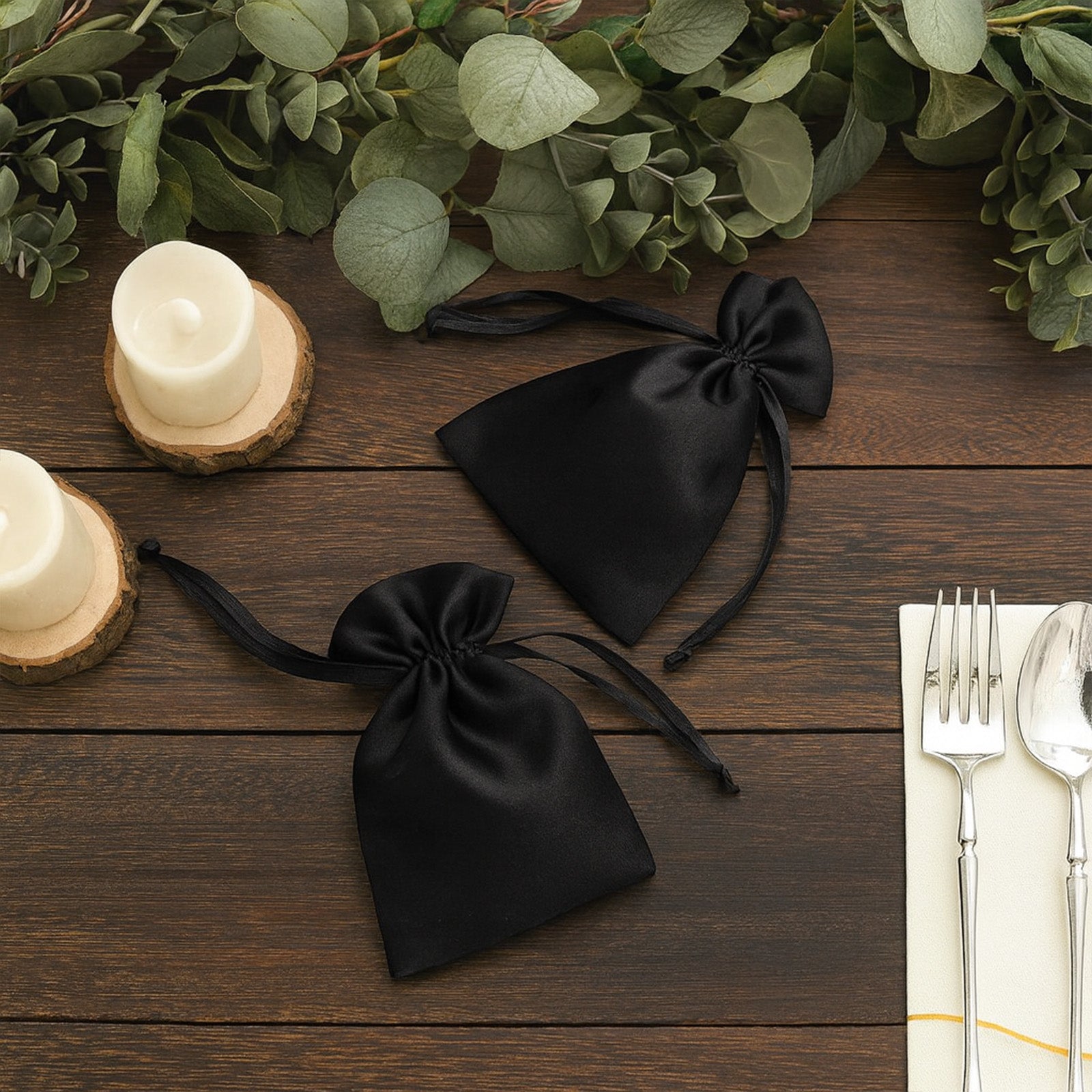 Black satin drawstring bags for wedding party favors.