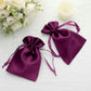 Purple satin drawstring gift bags for weddings and parties.