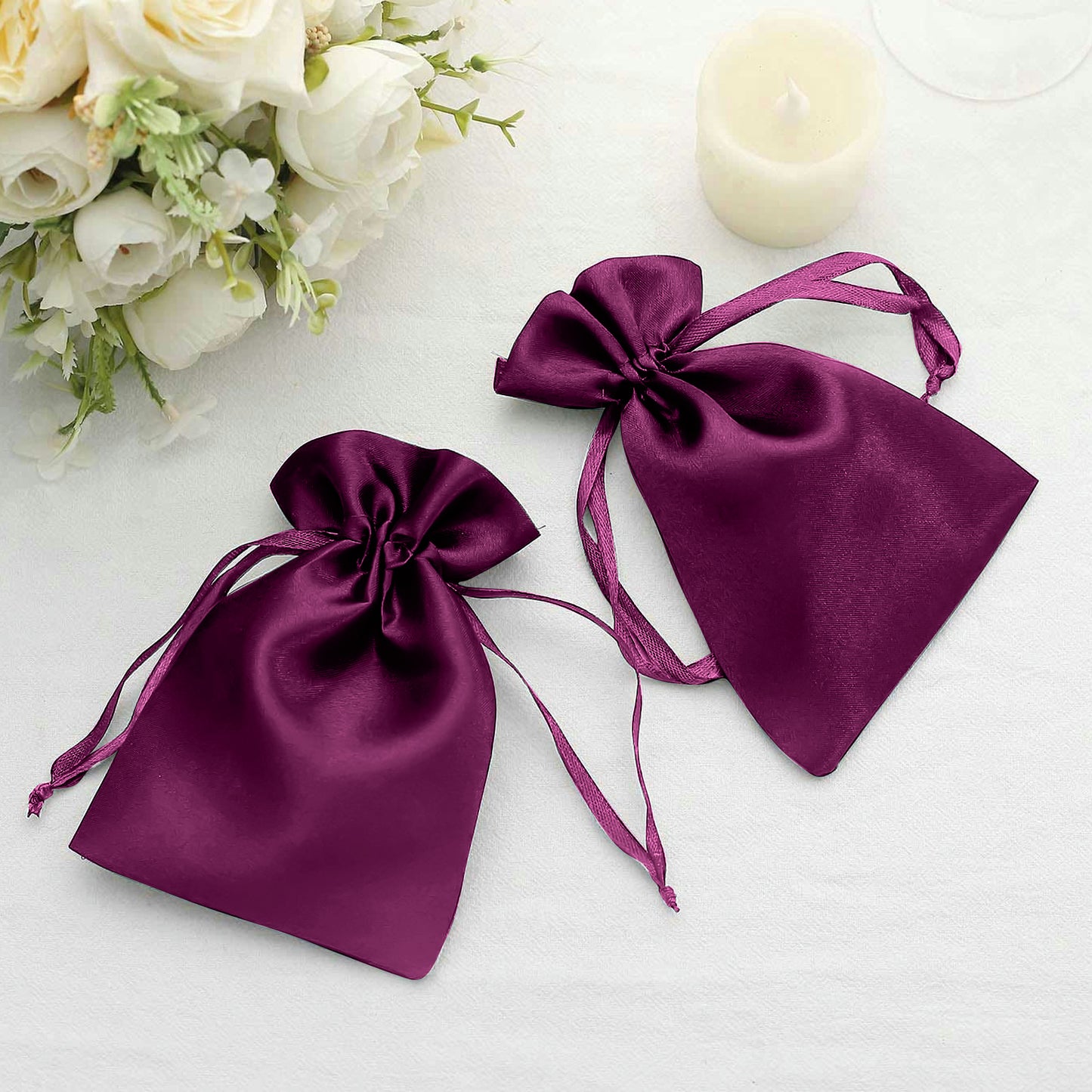 Purple satin drawstring gift bags for weddings and parties.
