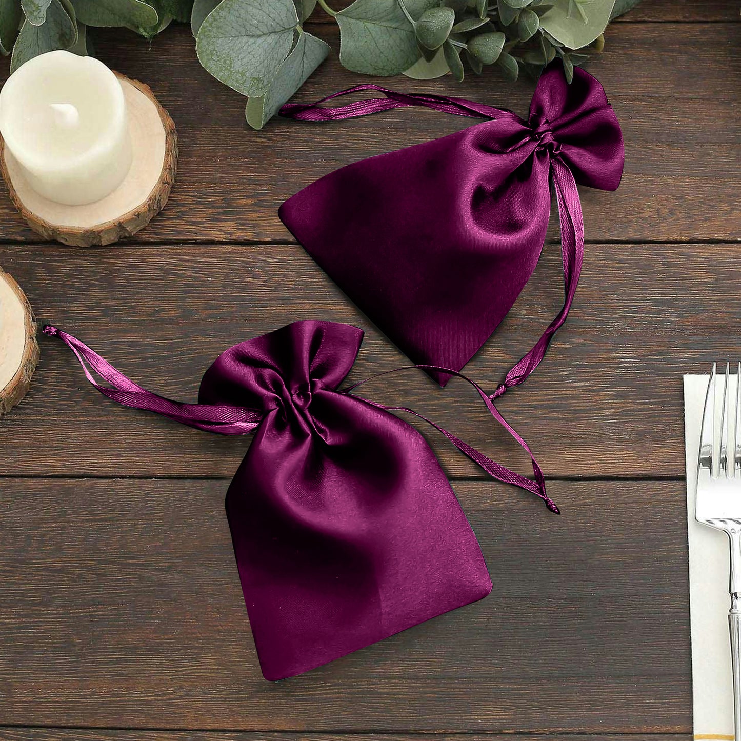 Eggplant satin drawstring pouches for wedding party favors.