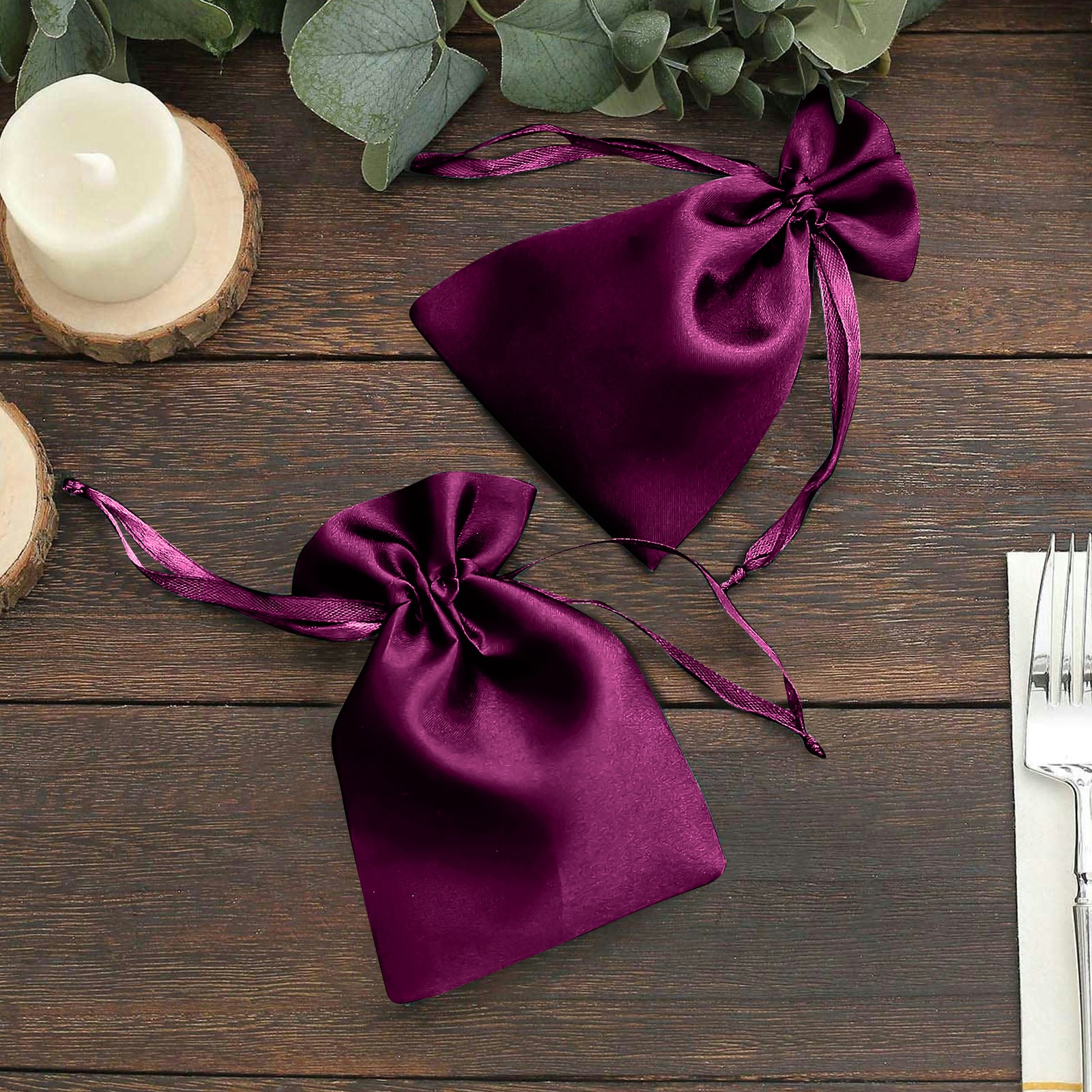 Eggplant satin drawstring pouches for wedding party favors.