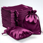 60 pack eggplant satin drawstring pouches for wedding party favors.