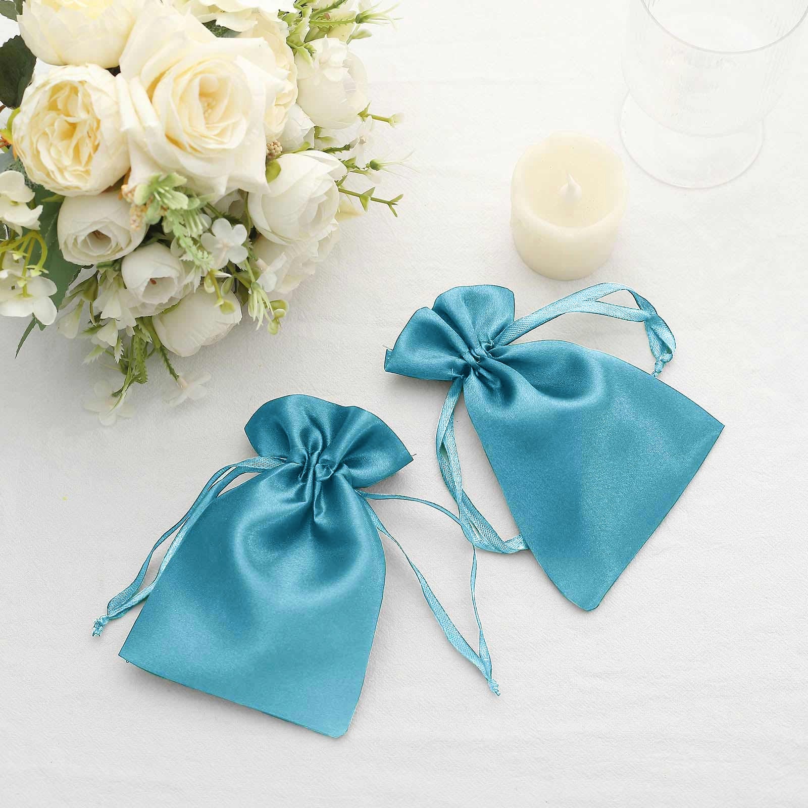 Turquoise satin drawstring pouches for wedding party favors.