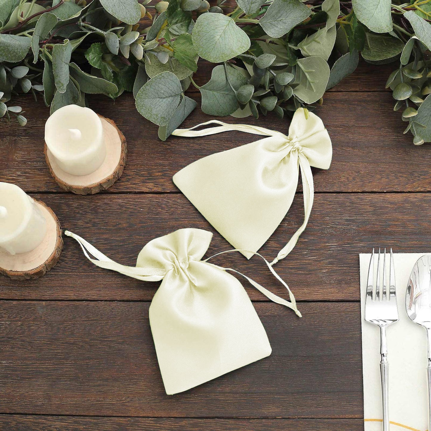 Yellow satin drawstring pouches for wedding party favors.