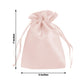 Blush satin drawstring gift bags for wedding party favors.