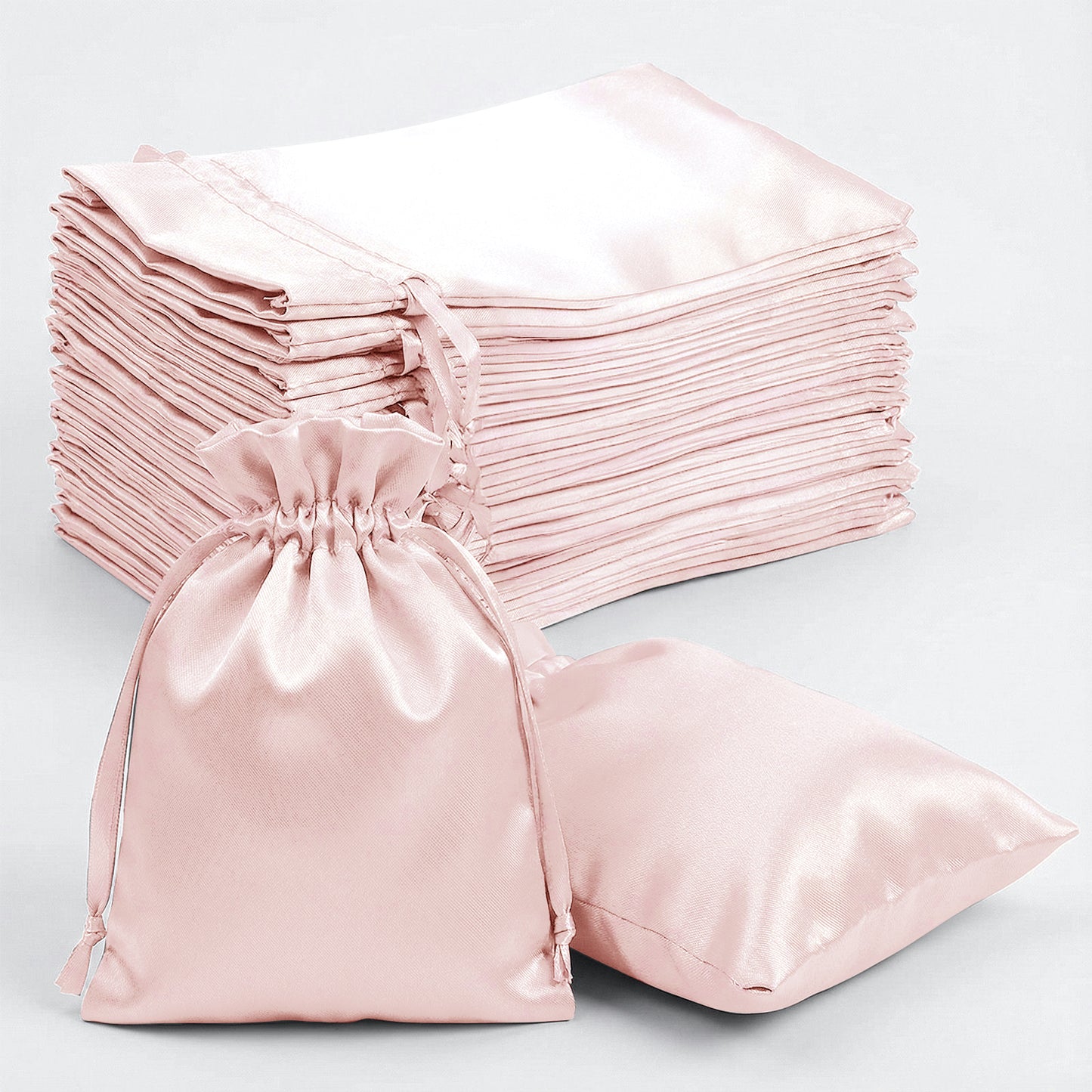 Blush satin drawstring gift bags for weddings and parties, 60 pack.
