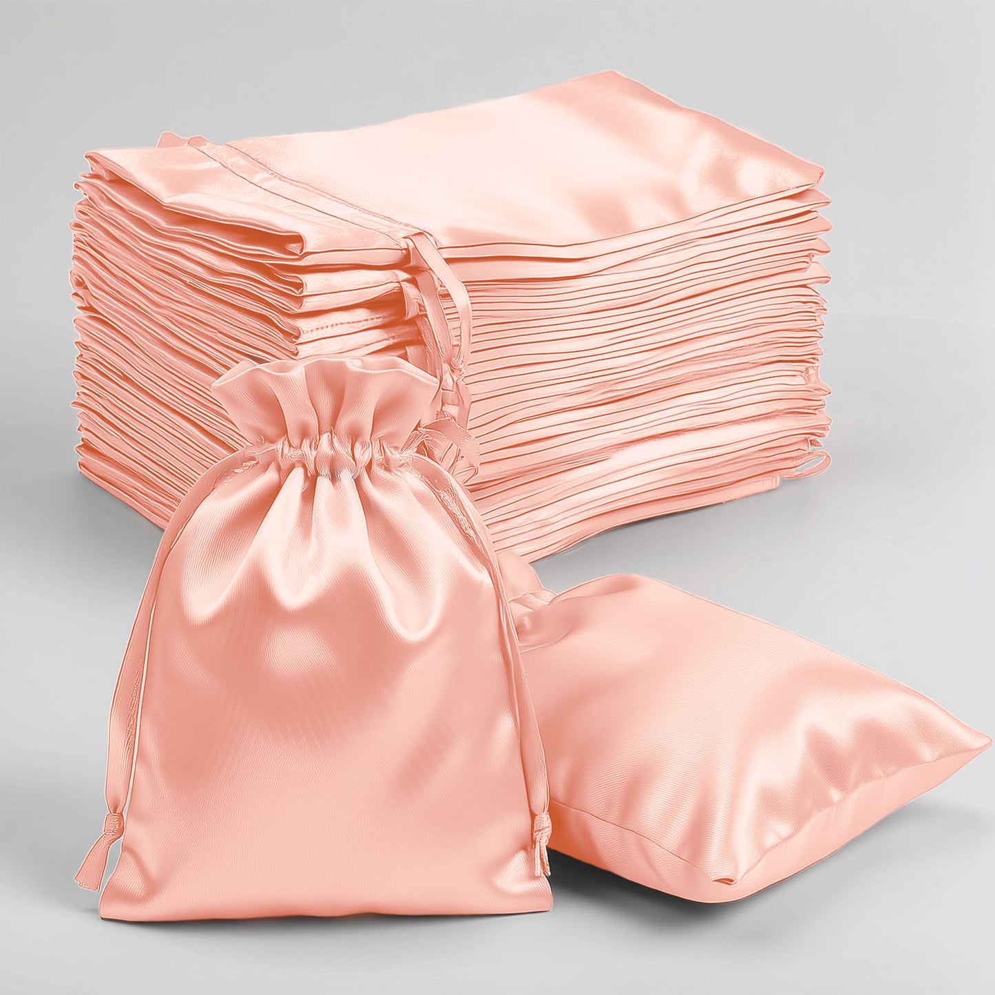 Dusty rose satin drawstring gift bags for weddings and parties.
