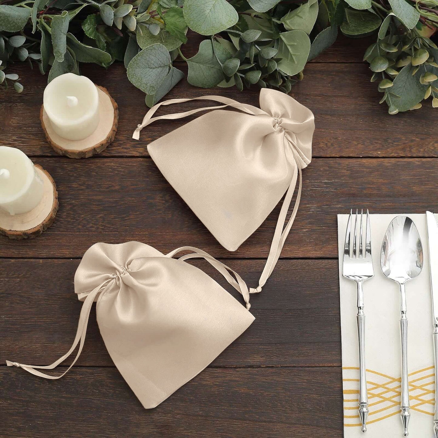 Beige satin drawstring gift bags for wedding favors.