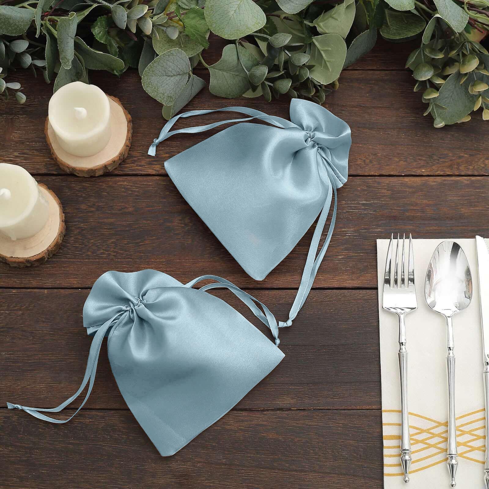 Dusty blue satin drawstring gift bags for wedding party favors.
