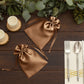 Antique gold satin drawstring gift bags for wedding party favors.