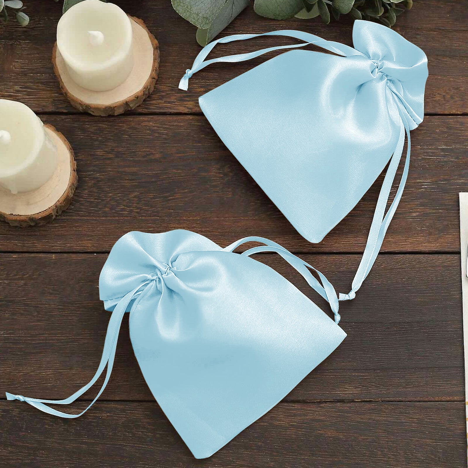 Light blue satin drawstring gift bags for weddings and parties.
