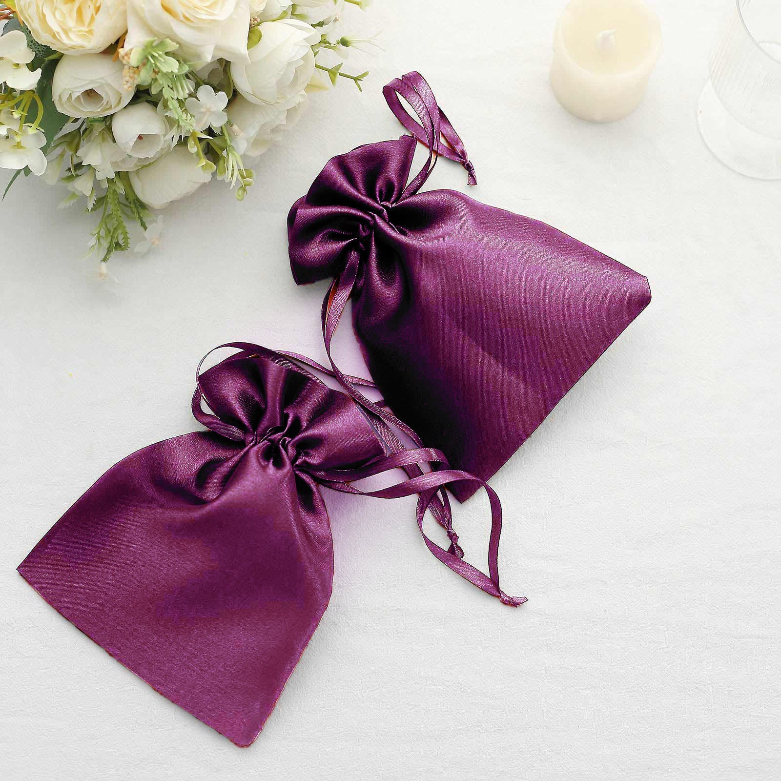 Eggplant satin drawstring gift bags for weddings or parties.