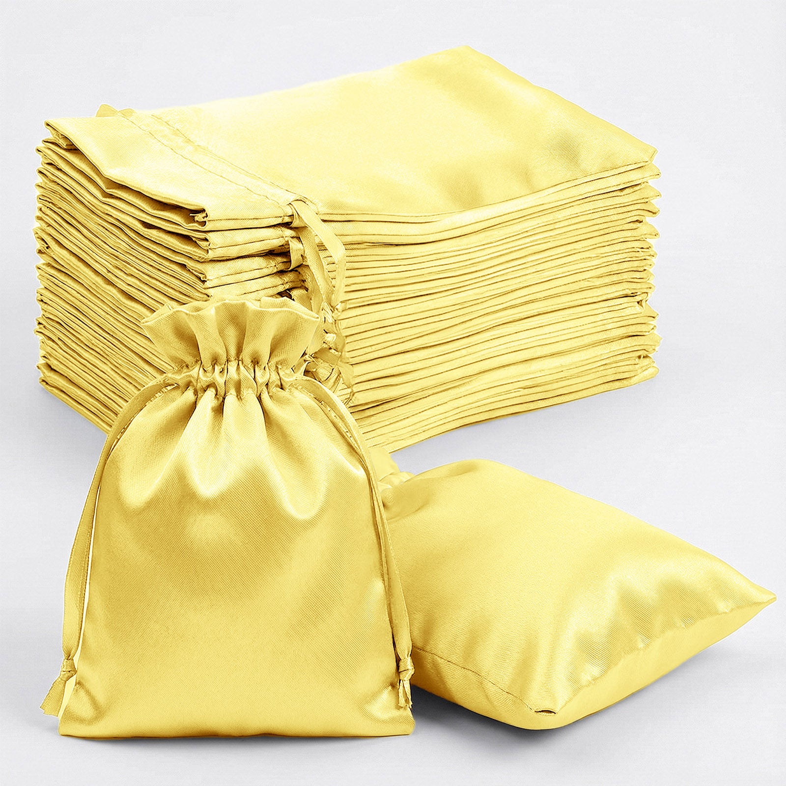 Gold satin drawstring favor gift bags, perfect for weddings and parties.