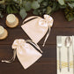 Peach satin drawstring gift bags for wedding party favors.