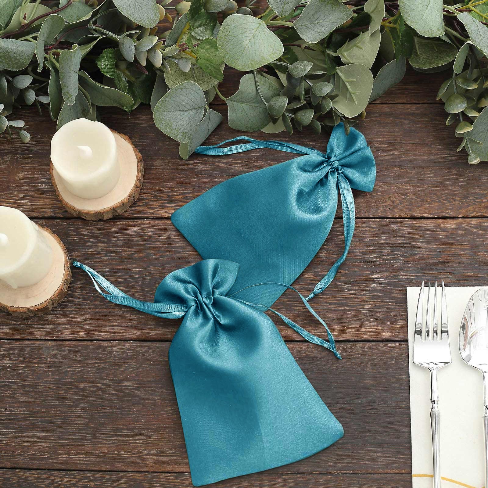 Turquoise satin drawstring gift bags for wedding party favors.
