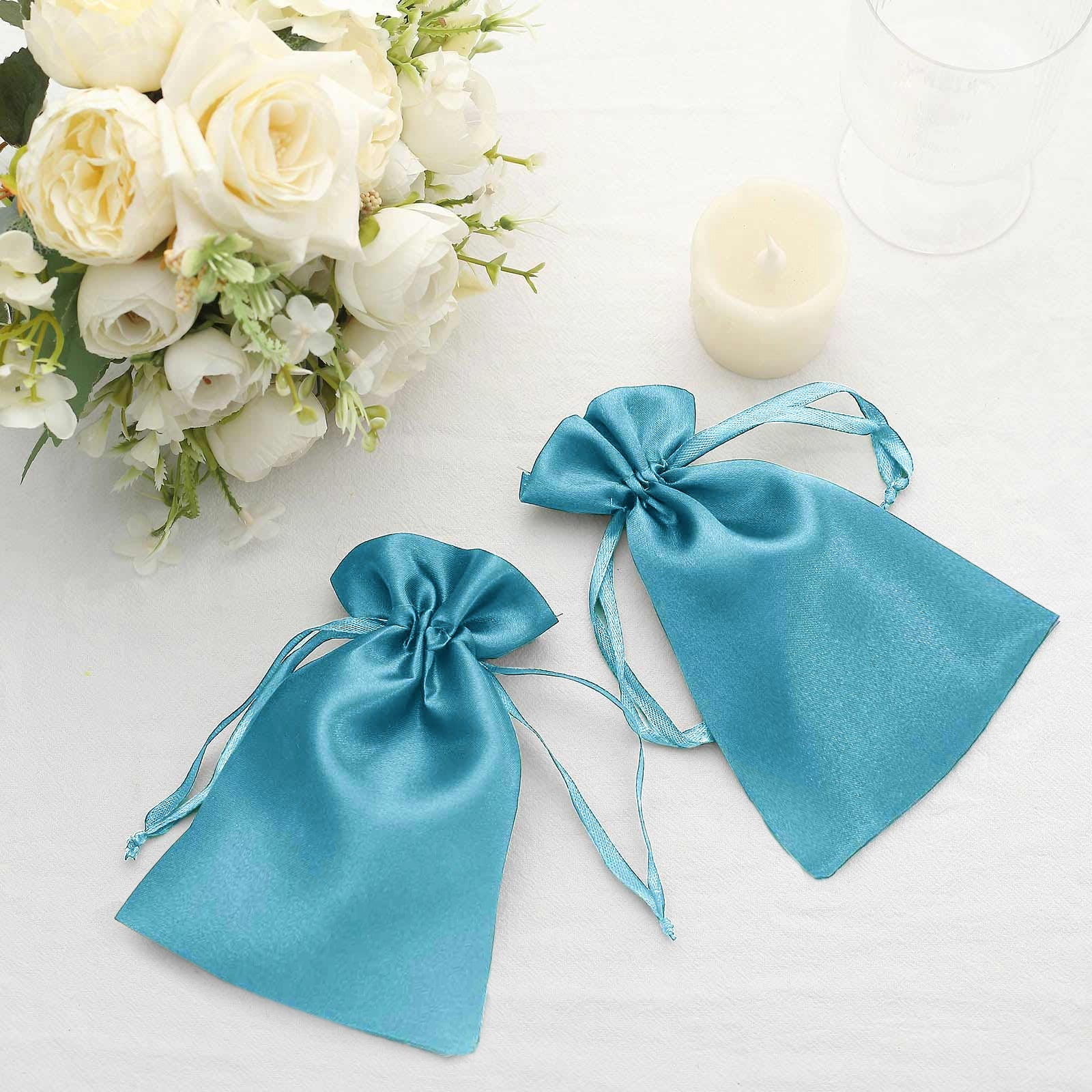 Turquoise satin drawstring gift bags for weddings and parties.